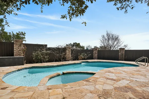 a view of a swimming pool with a yard