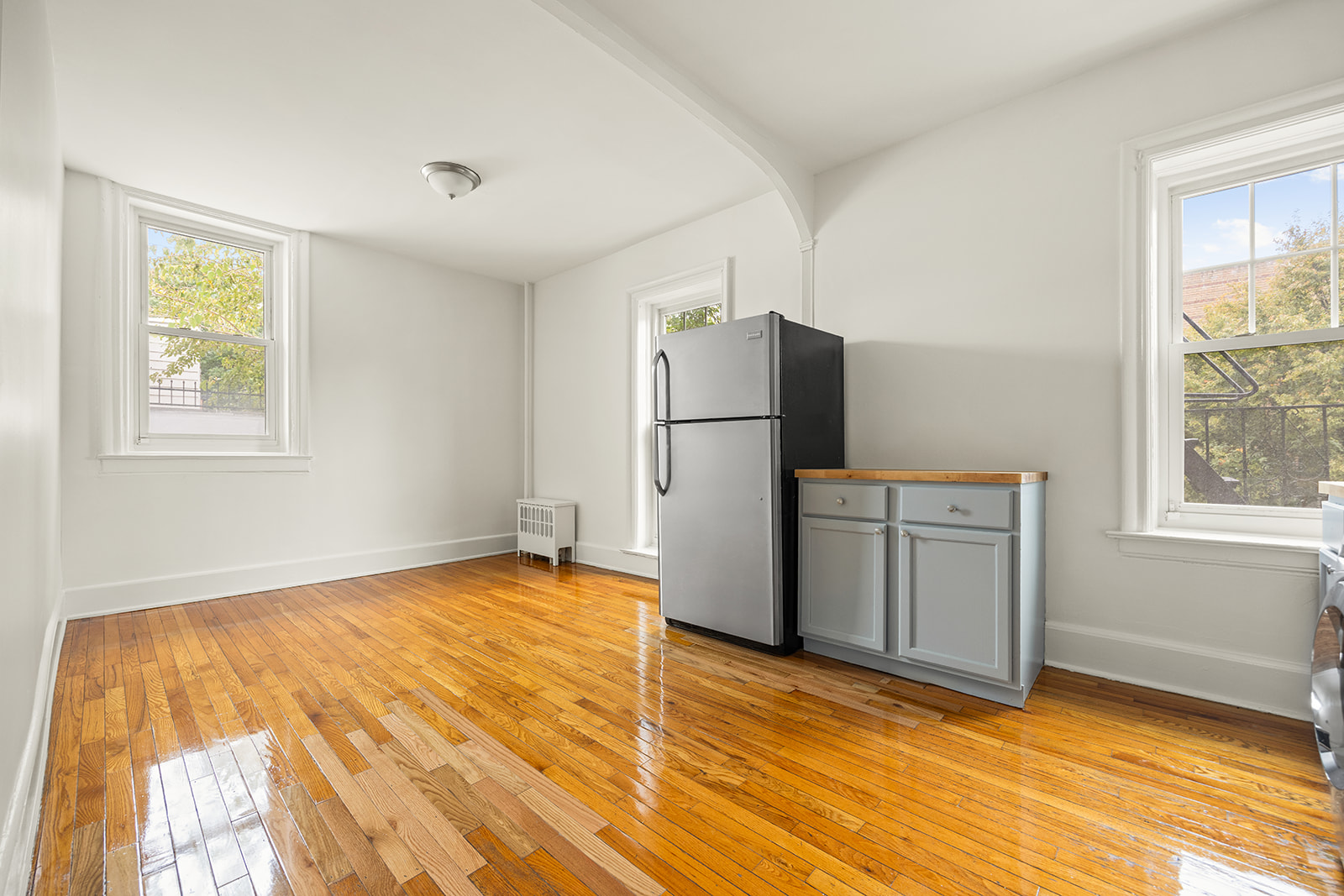 1523 11th Avenue, Unit 2 Brooklyn, NY 11215 - Photo 4 of 11 a view of a kitchen with wooden floor and electronic appliances