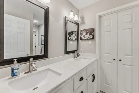 a bathroom with a tub shower and vanity