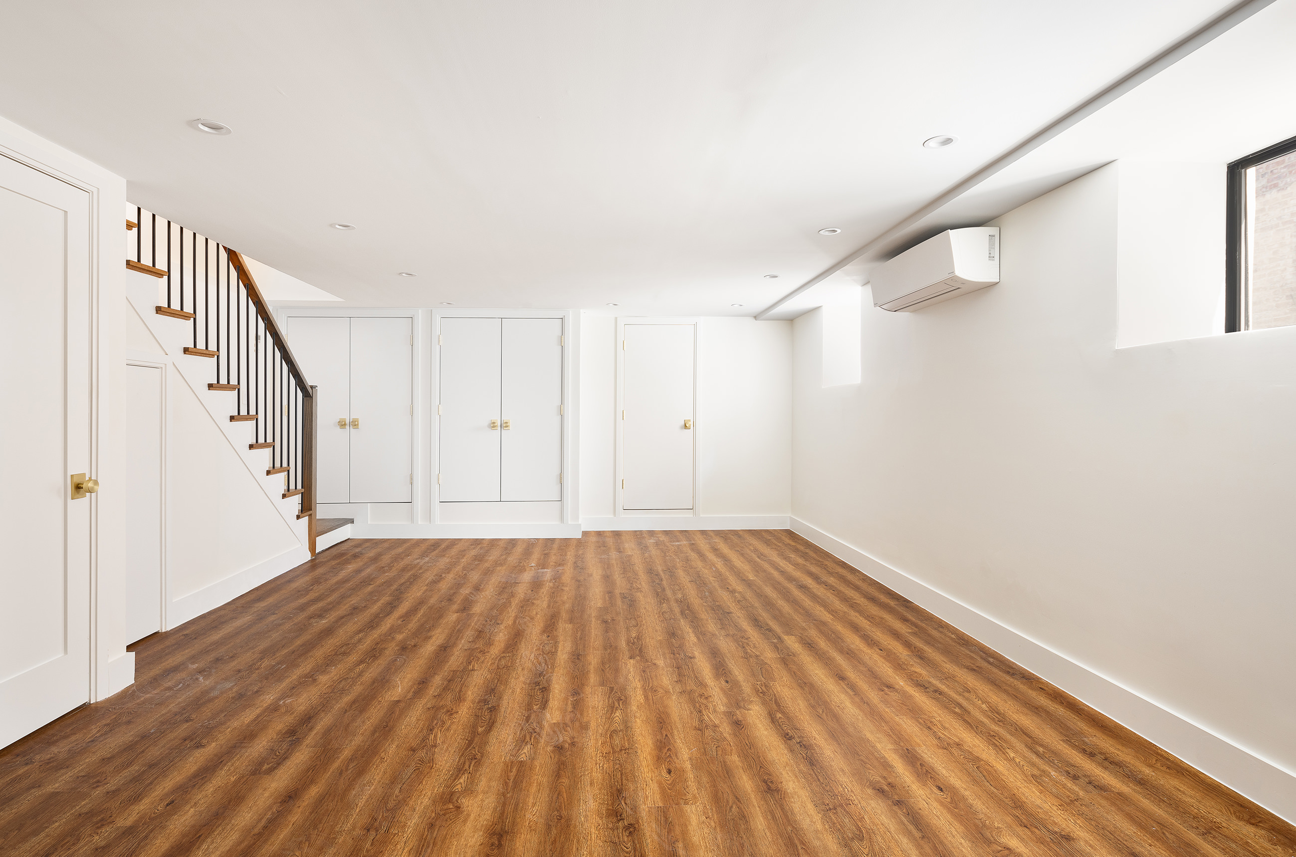 282 Buffalo Avenue, Unit 1 Brooklyn, NY 11213 - Photo 7 of 9 a view of an empty room with wooden floor and stairs
