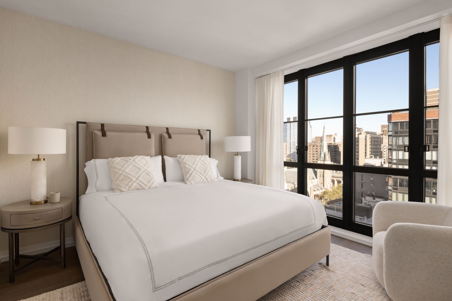 a bedroom with a large bed and a large window