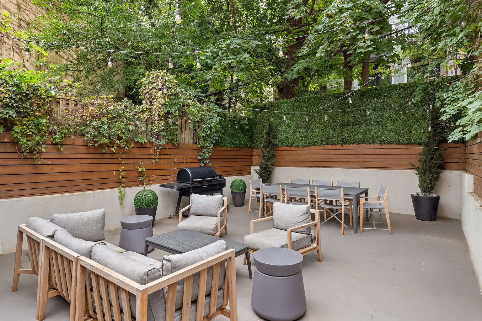 a view of a patio with couches table and chairs and potted plants