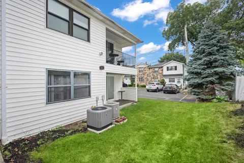 a front view of a house with a garden and yard