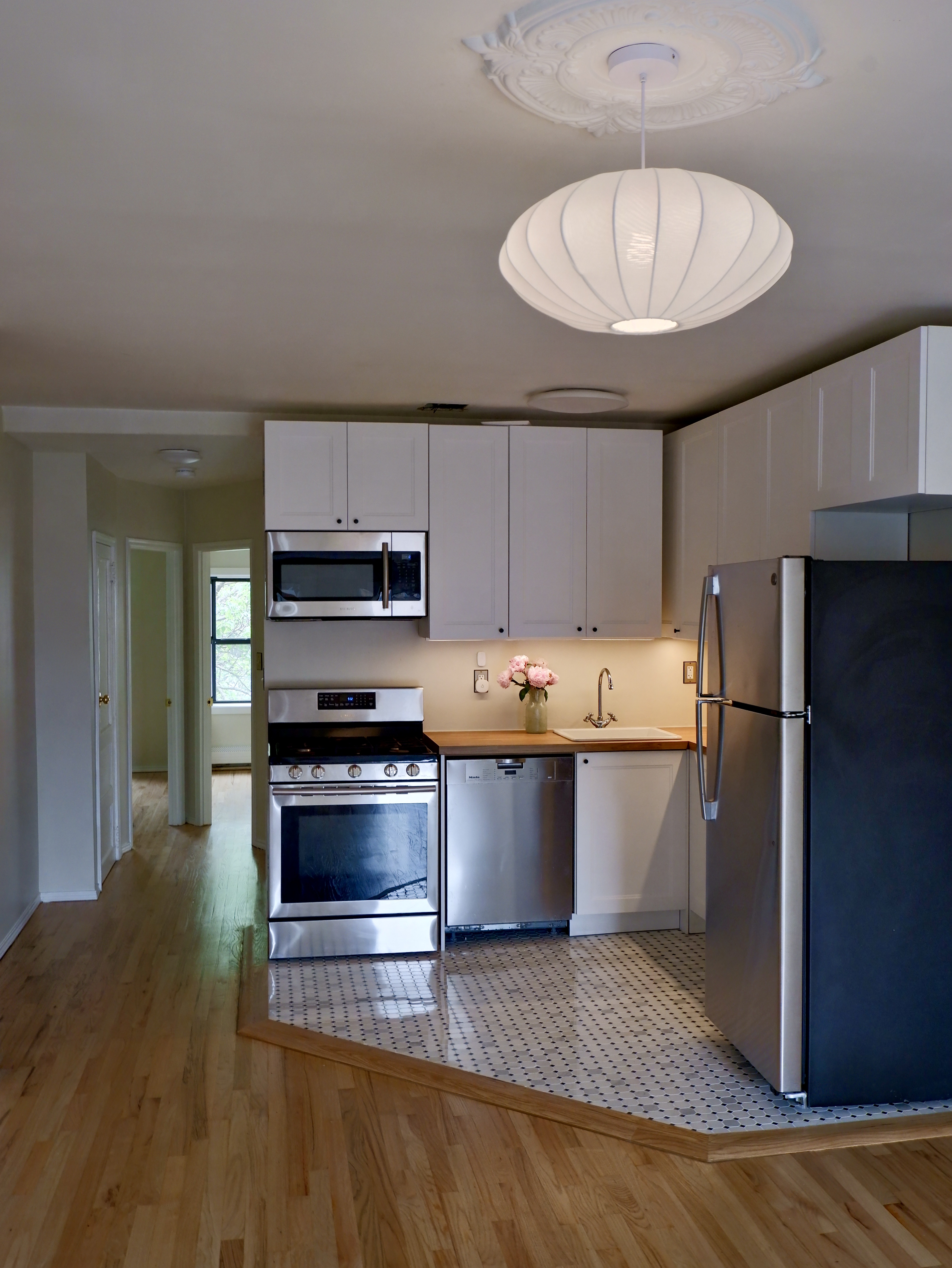 132 Decatur Street, Unit 3 Brooklyn, NY 11216 - Photo 11 of 17 a large kitchen with stainless steel appliances a stove refrigerator sink and cabinets