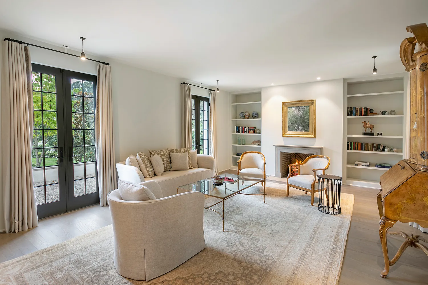 a living room with fireplace furniture and a large window