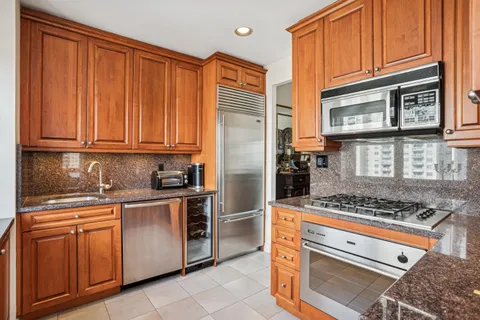 a kitchen with stainless steel appliances granite countertop a stove and a refrigerator