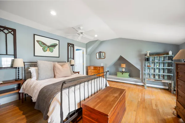 a bedroom with a bed and a book shelf