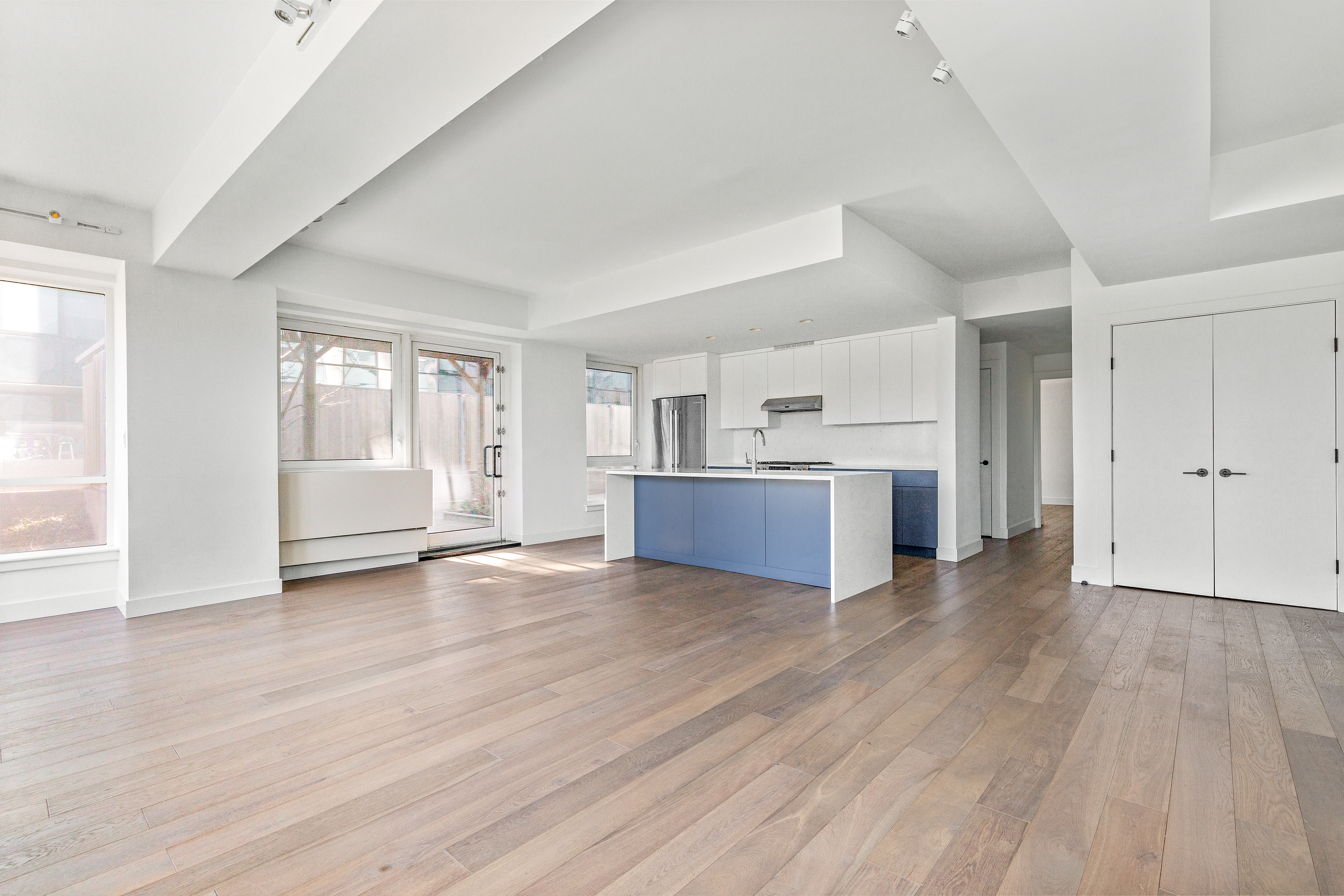 440 Kent Avenue, Unit 1B Brooklyn, NY 11249 - Photo 2 of 20 a view of a kitchen with wooden floor and a sink
