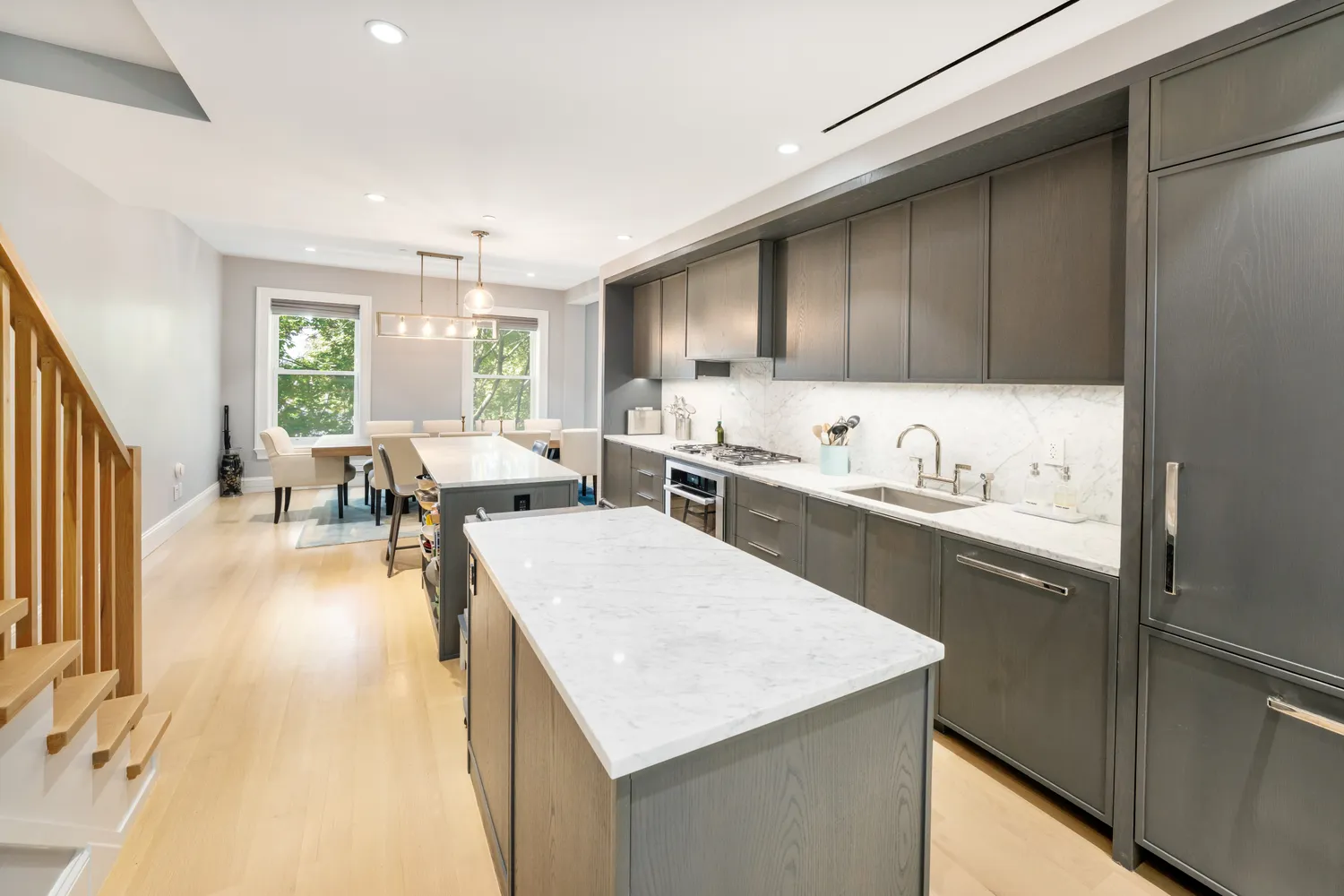a kitchen with a table chairs refrigerator and cabinets