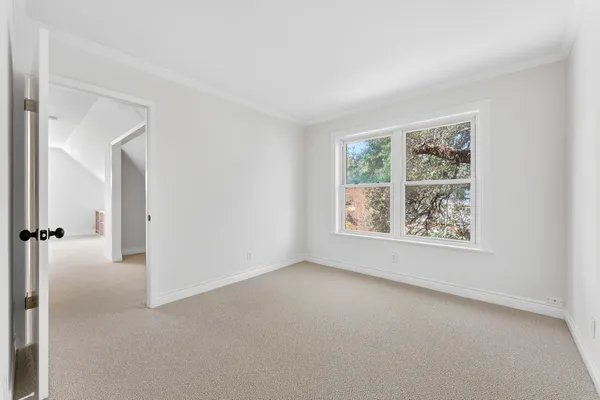an empty room with windows and closet
