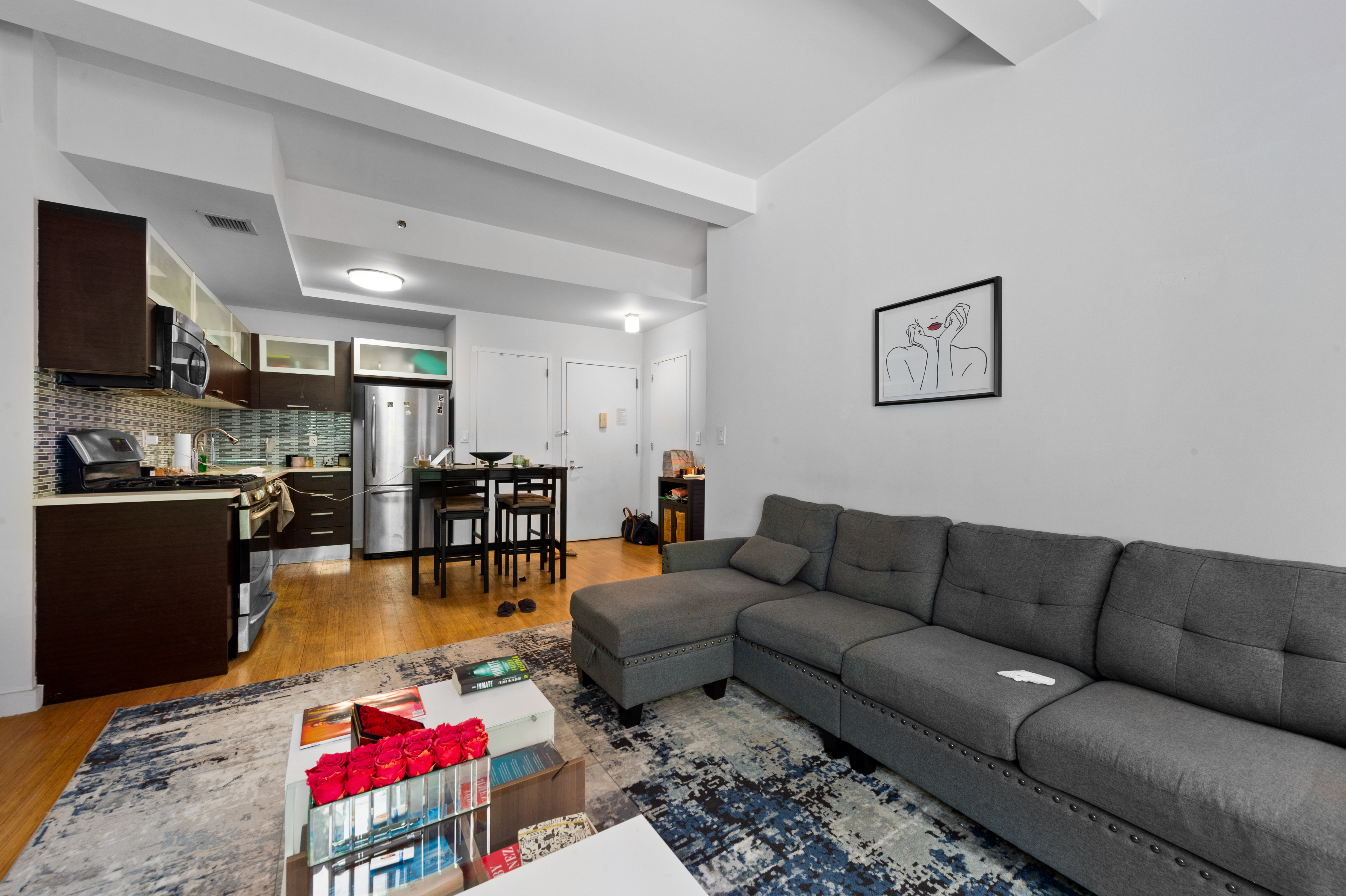 353 East 104th Street, Unit 2F Manhattan, NY 10029 - Photo 2 of 10 a living room with furniture and a kitchen view