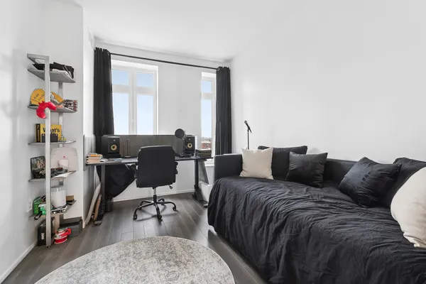 a living room with furniture and wooden floor