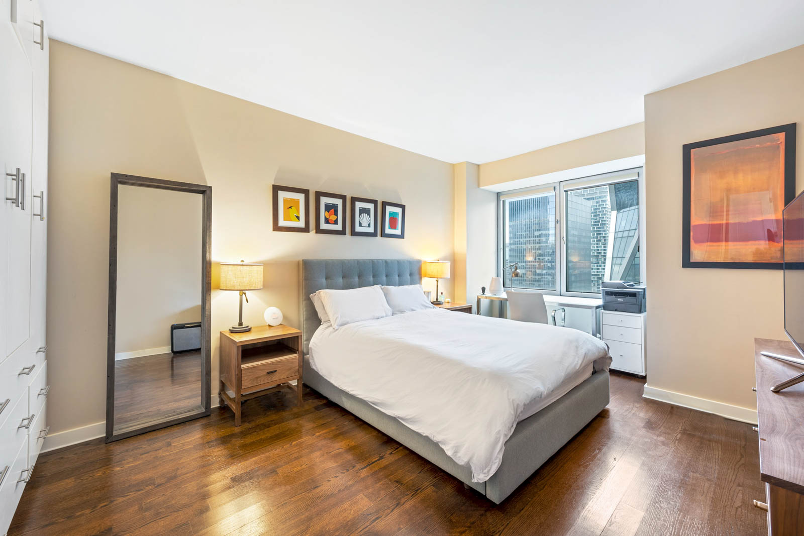 301 West 57th Street, Unit 44E Manhattan, NY 10019 - Photo 3 of 11 a bedroom with a bed and wooden floor