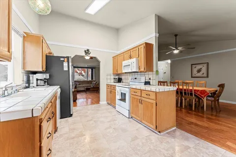 a kitchen with stainless steel appliances kitchen island granite countertop a sink and cabinets
