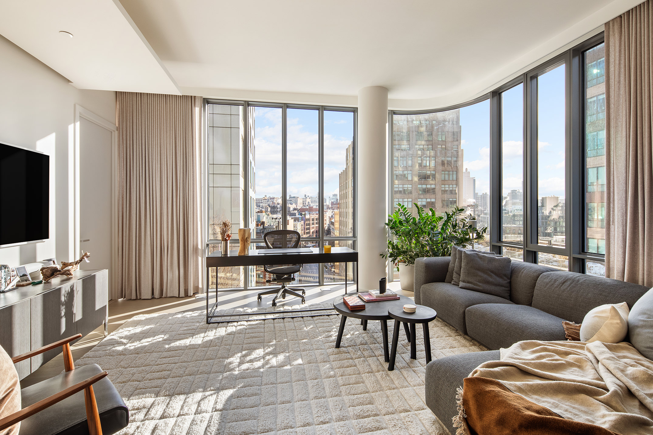 565 Broome Street, Unit S11E Manhattan, NY 10013 - Photo 5 of 11 a living room with furniture and a flat screen tv