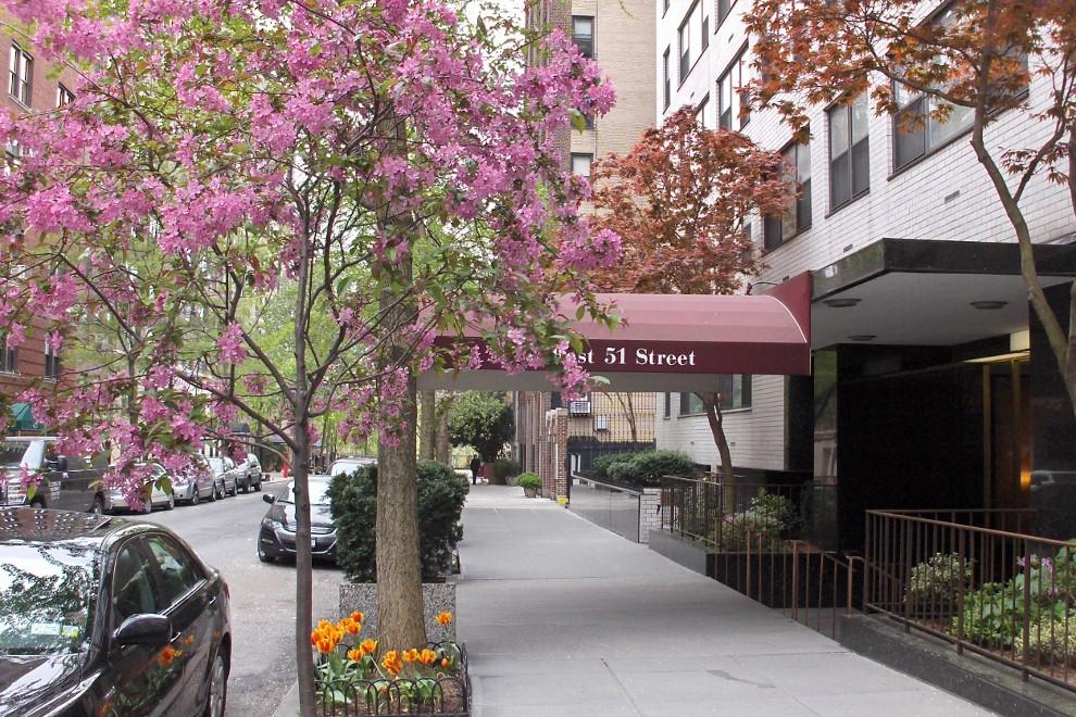 420 East 51st Street, Unit 10H Manhattan, NY 10022 - Photo 12 of 14 a street sign on a sidewalk next to a road