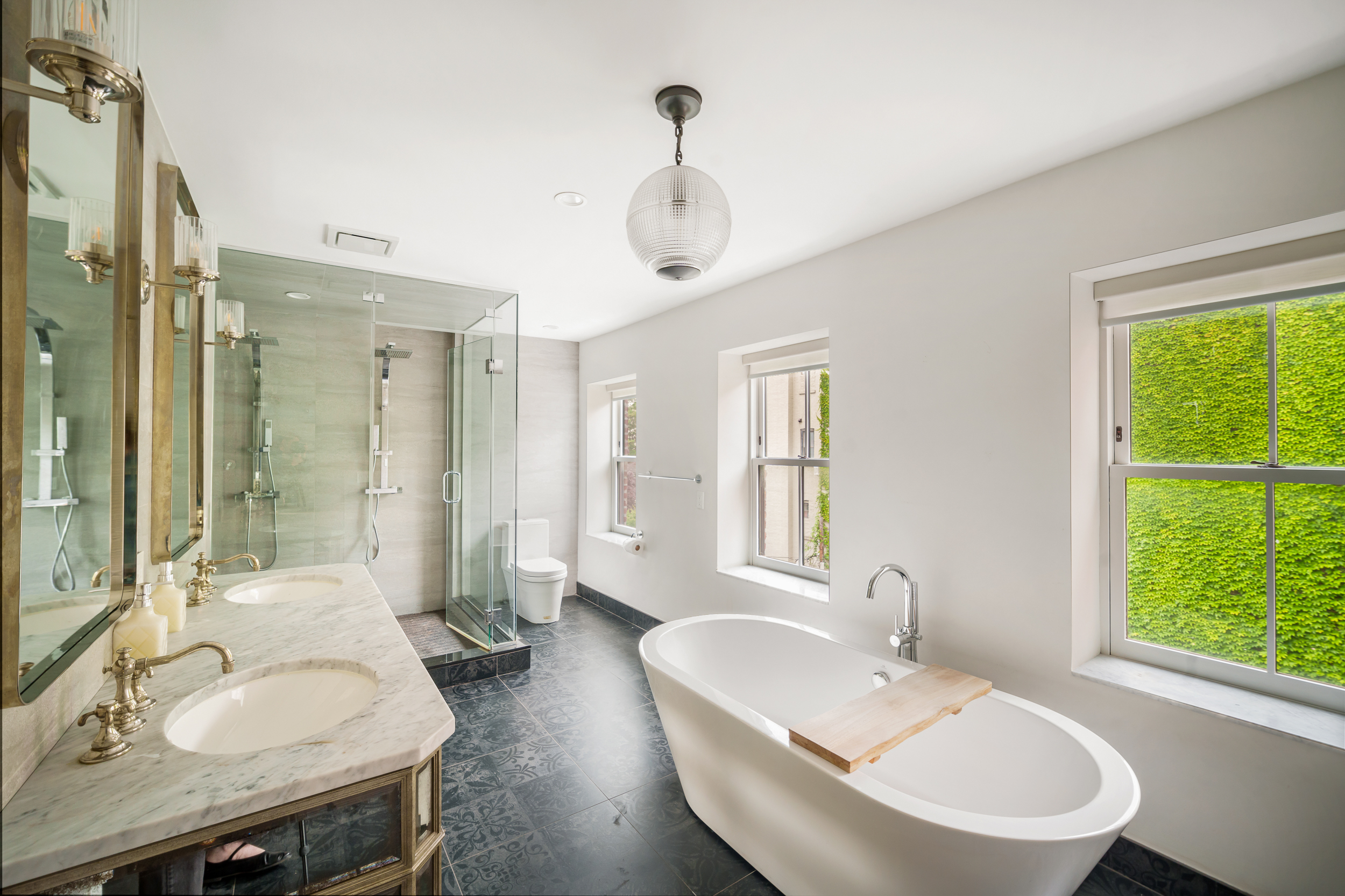 265 6th Avenue Brooklyn, NY 11215 - Photo 15 of 24 a bathroom with a granite countertop sink mirror and a bathtub