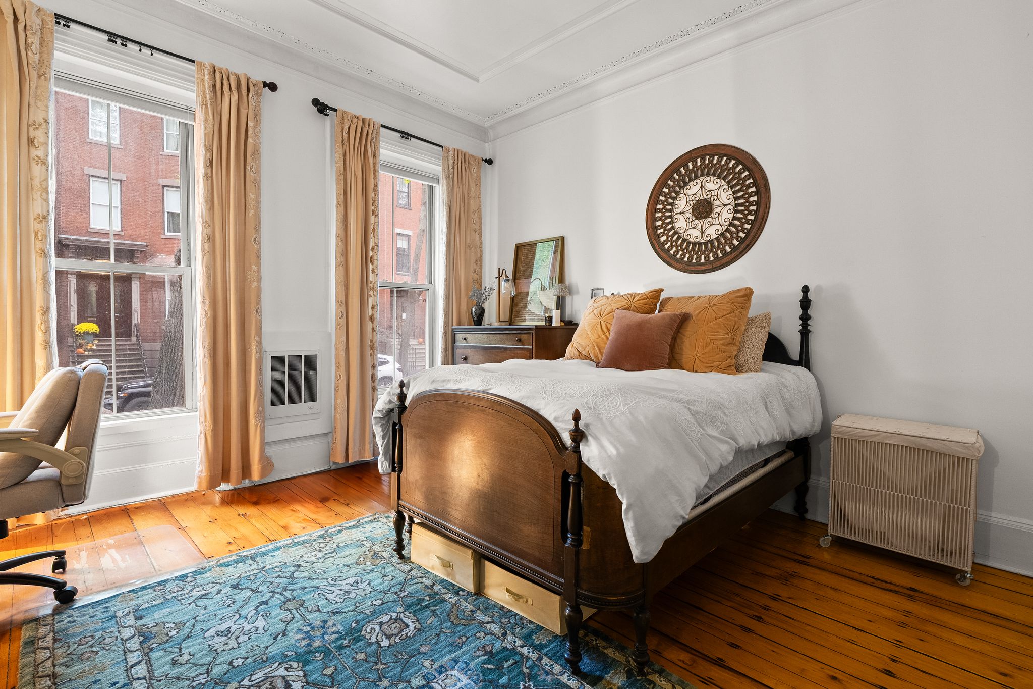 46 East Springfield Street, Unit 2 Boston, MA 02118 - Photo 2 of 10 a bedroom with a bed lamp and a large window with wooden floor