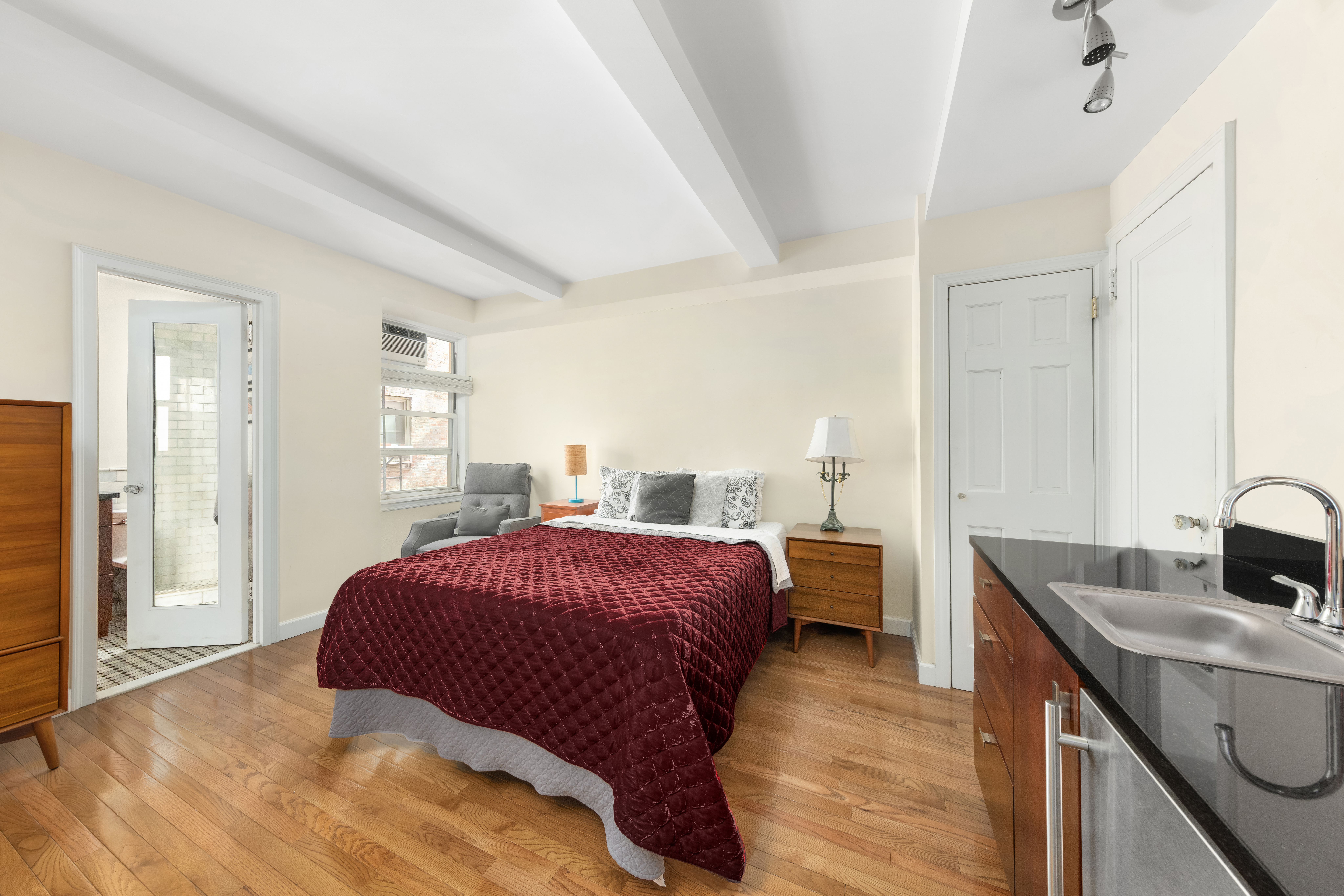 333 East 43rd Street, Unit 110/111 Manhattan, NY 10017 - Photo 3 of 16 a bedroom with a bed and a sink