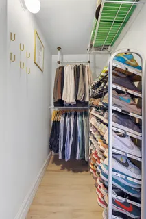 a view of walk in closet with clothes and shoes