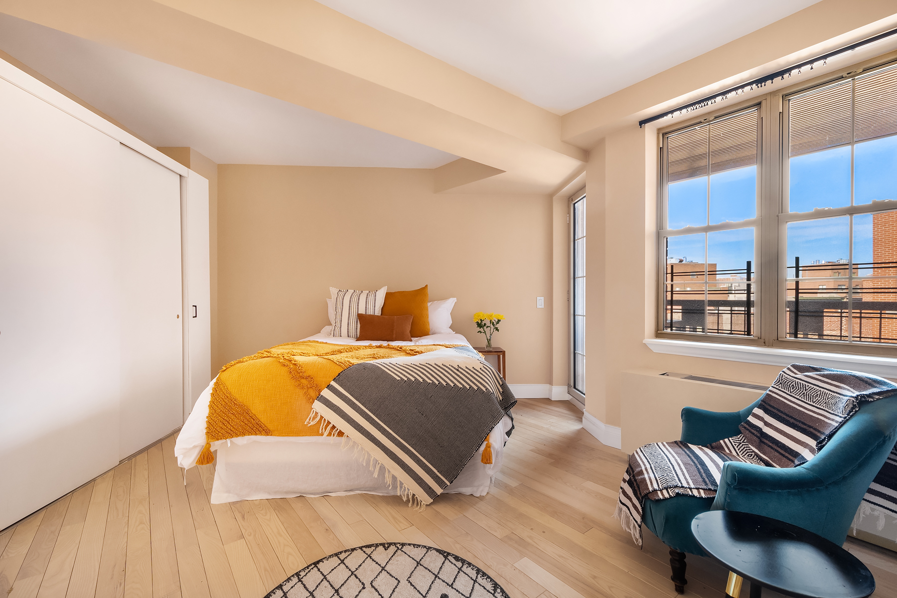 163 St Nicholas Avenue, Unit PH7A Manhattan, NY 10026 - Photo 6 of 11 a bedroom with a bed and a large window