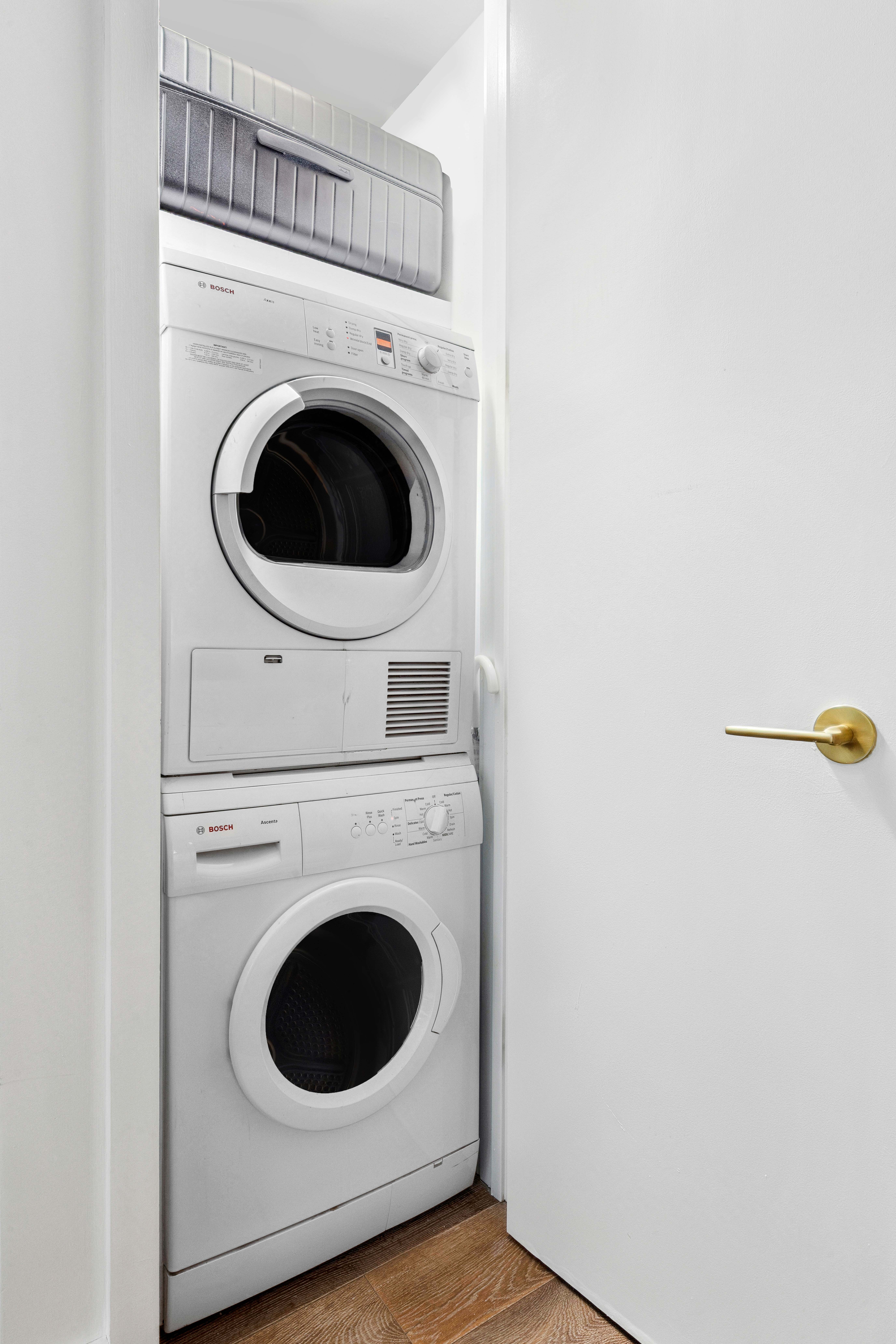 93 Worth Street, Unit 406 Manhattan, NY 10013 - Photo 6 of 11 a utility room with dryer and washer