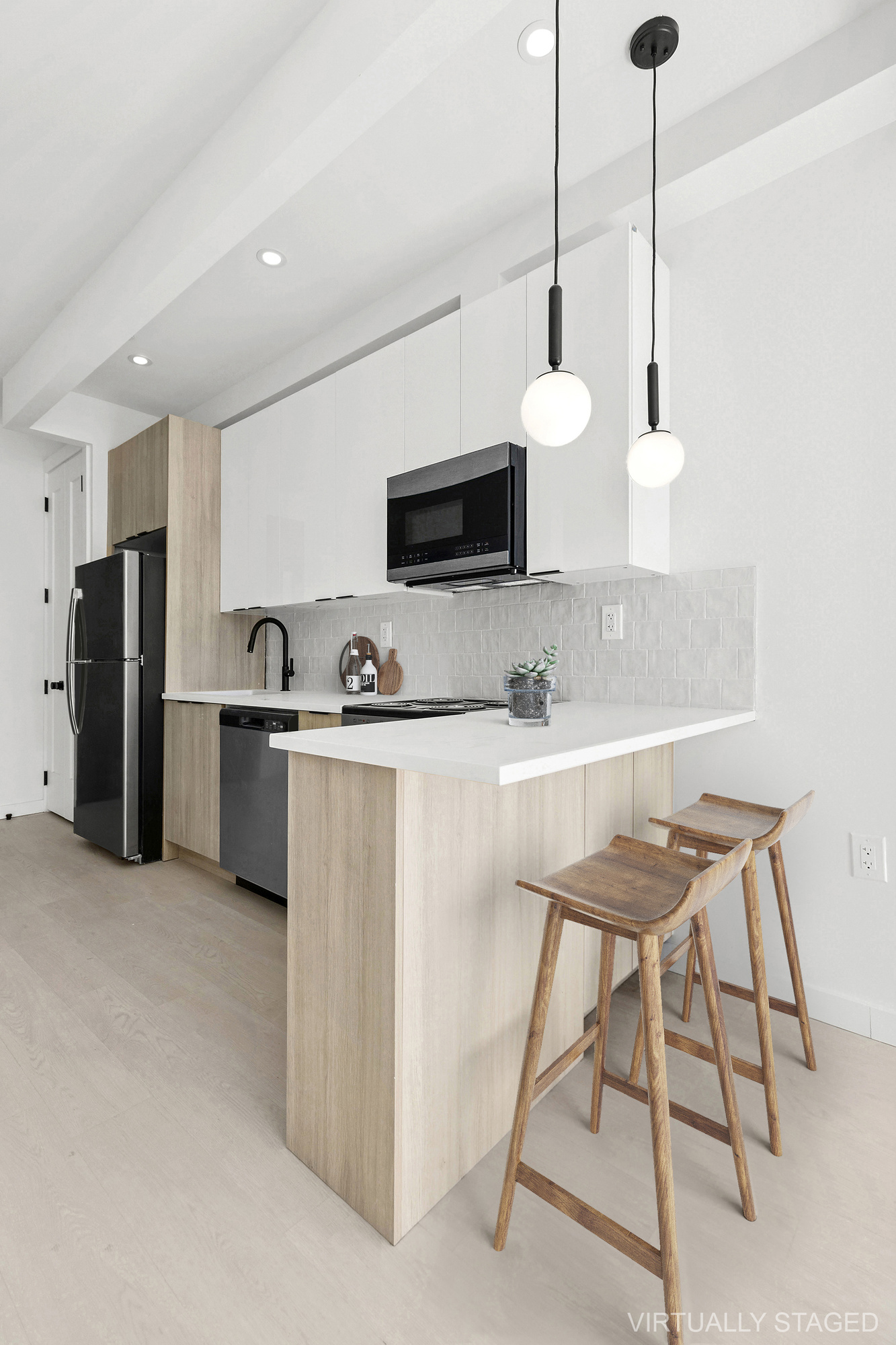 647 Dekalb Avenue, Unit 2A Brooklyn, NY 11216 - Photo 3 of 6 a kitchen with stainless steel appliances kitchen island granite countertop a sink and a refrigerator