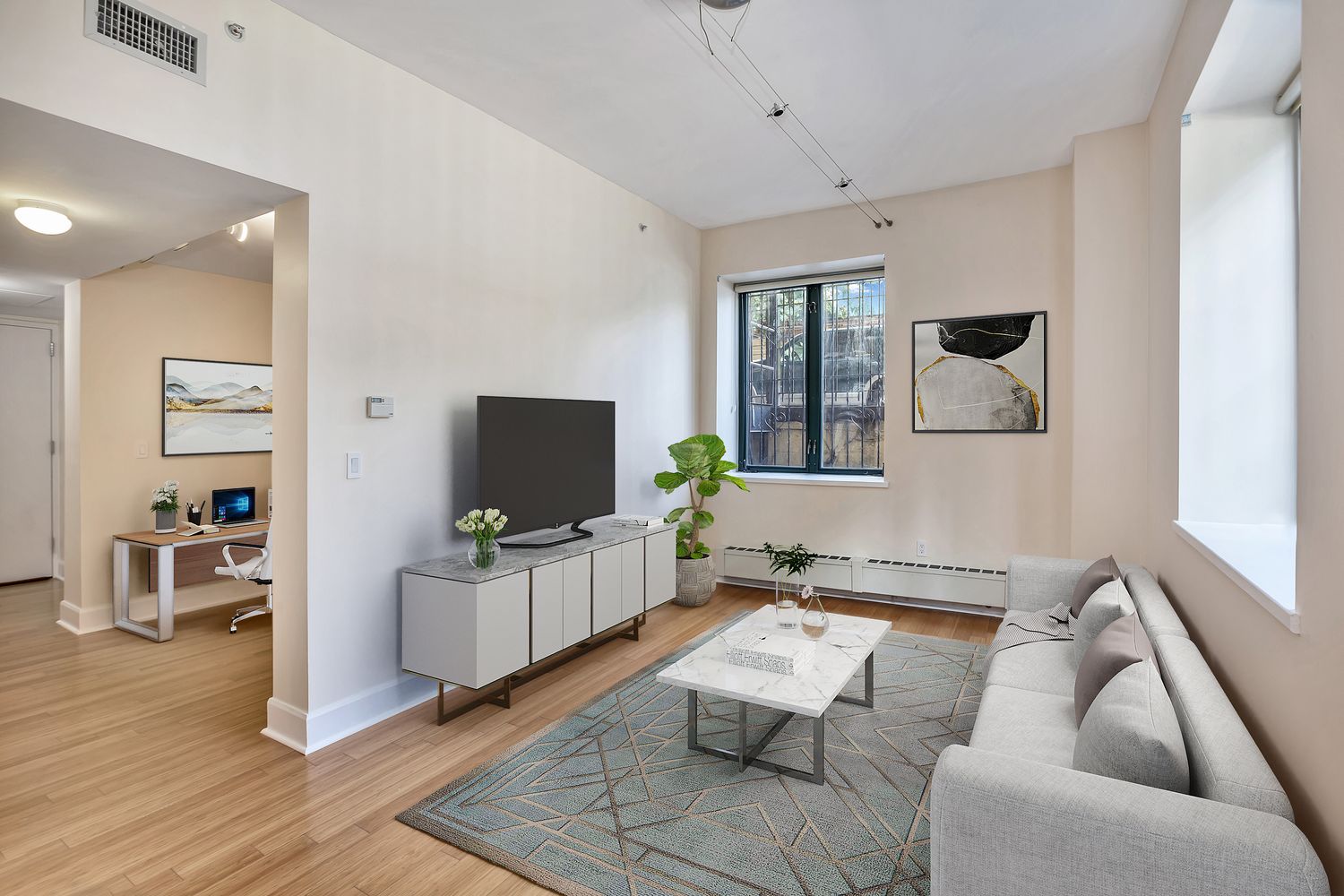 2056 5th Avenue, Unit 2B Manhattan, NY 10035 - Photo 8 of 13 a living room with furniture and a flat screen tv