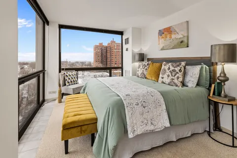 a bed sitting in a bedroom next to a large window