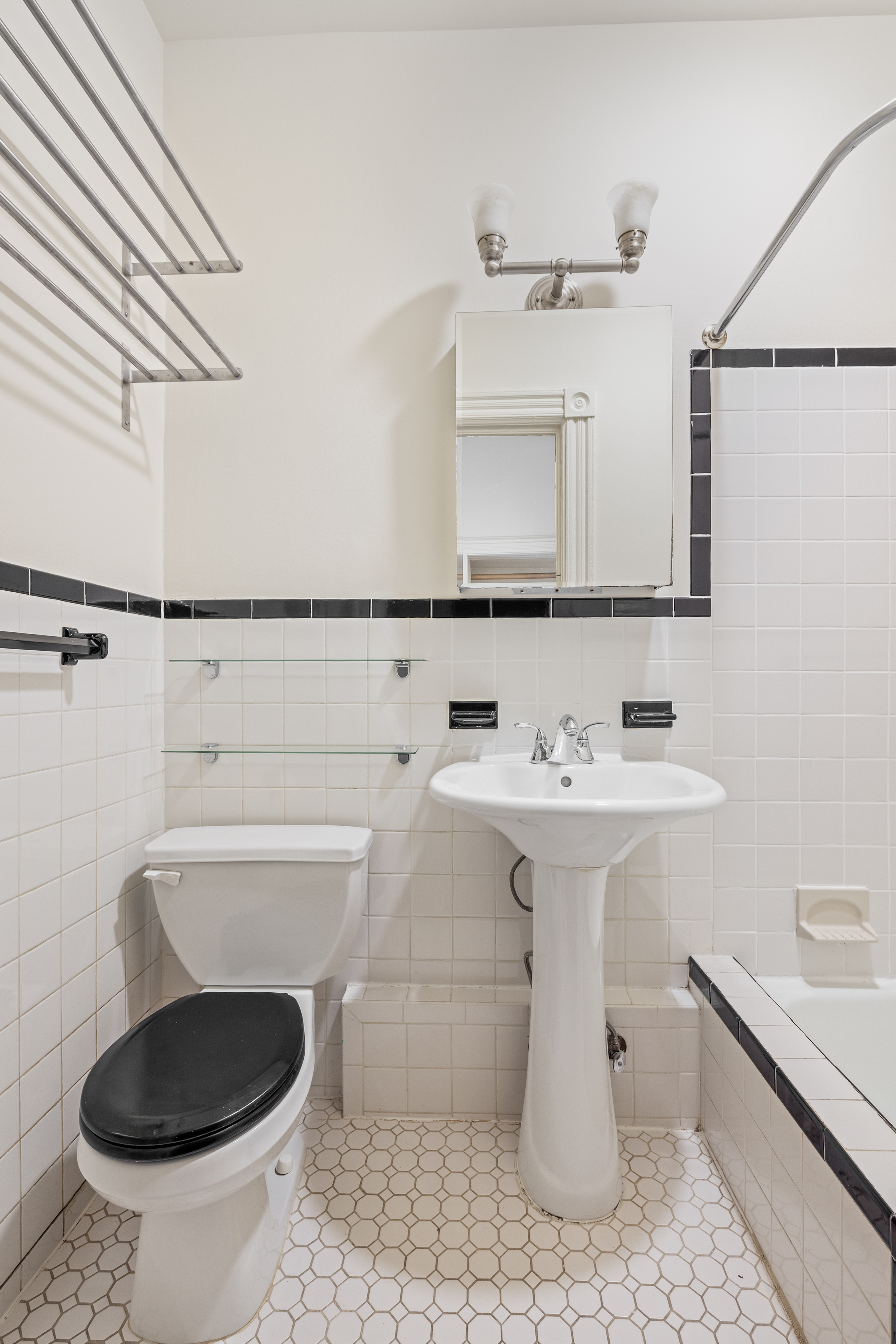 353 7th Avenue, Unit 1 Brooklyn, NY 11215 - Photo 7 of 8 a bathroom with a sink a toilet and a mirror