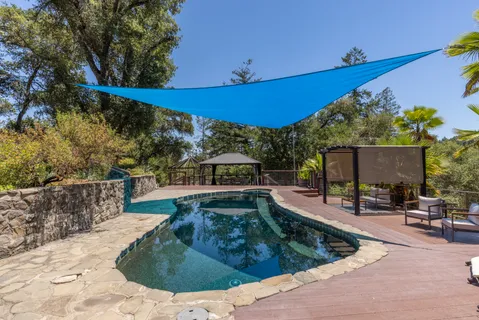 a view of a backyard with sitting area