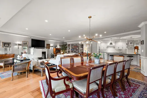 a kitchen with cabinets and chairs
