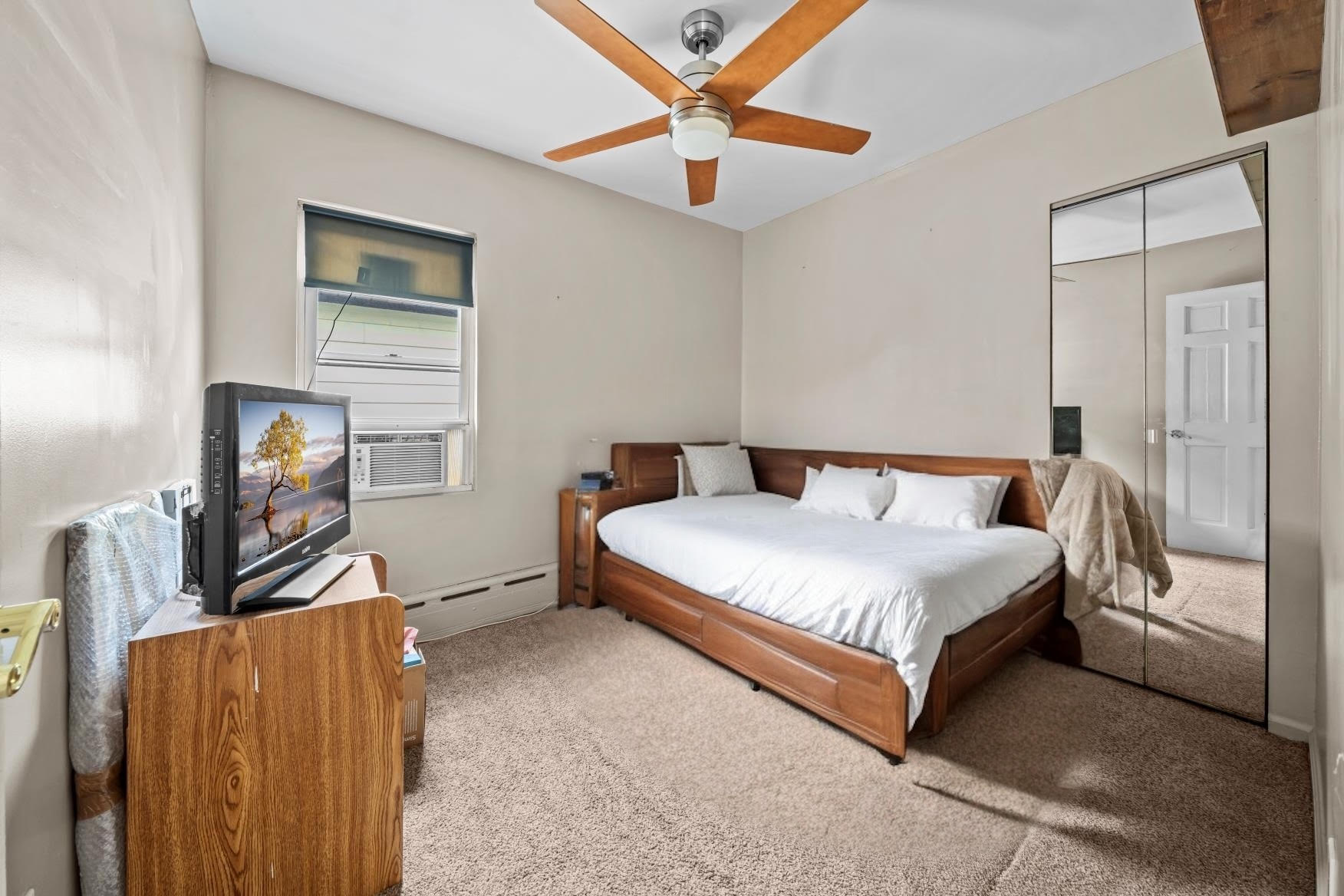 2018 Mill Avenue Brooklyn, NY 11234 - Photo 14 of 20 a spacious bedroom with a bed and a flat screen tv