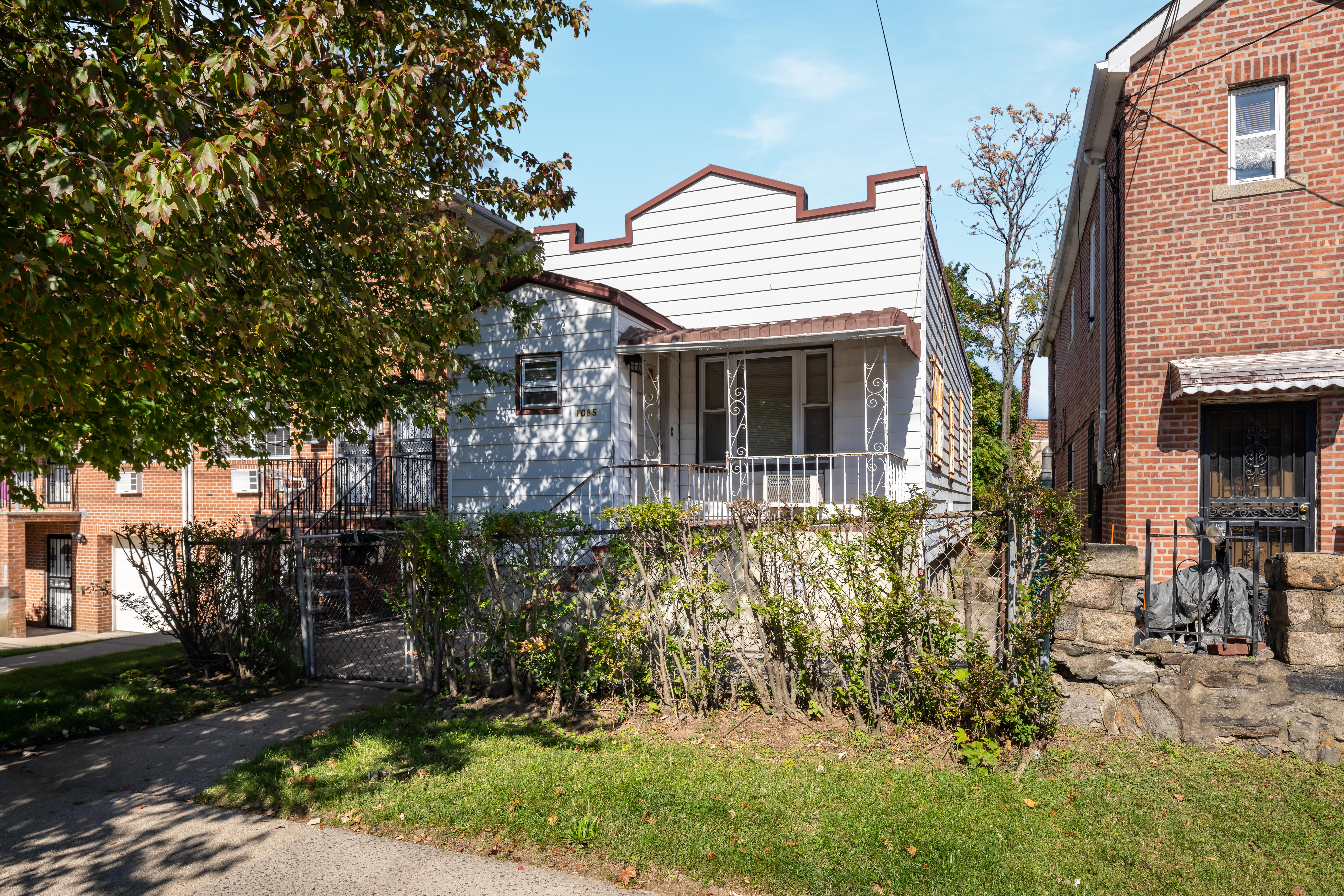 1085 Arnow Avenue Bronx, NY 10469 - Photo 16 of 16 a front view of a house with a yard