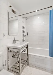 a bathroom with a shower and a sink