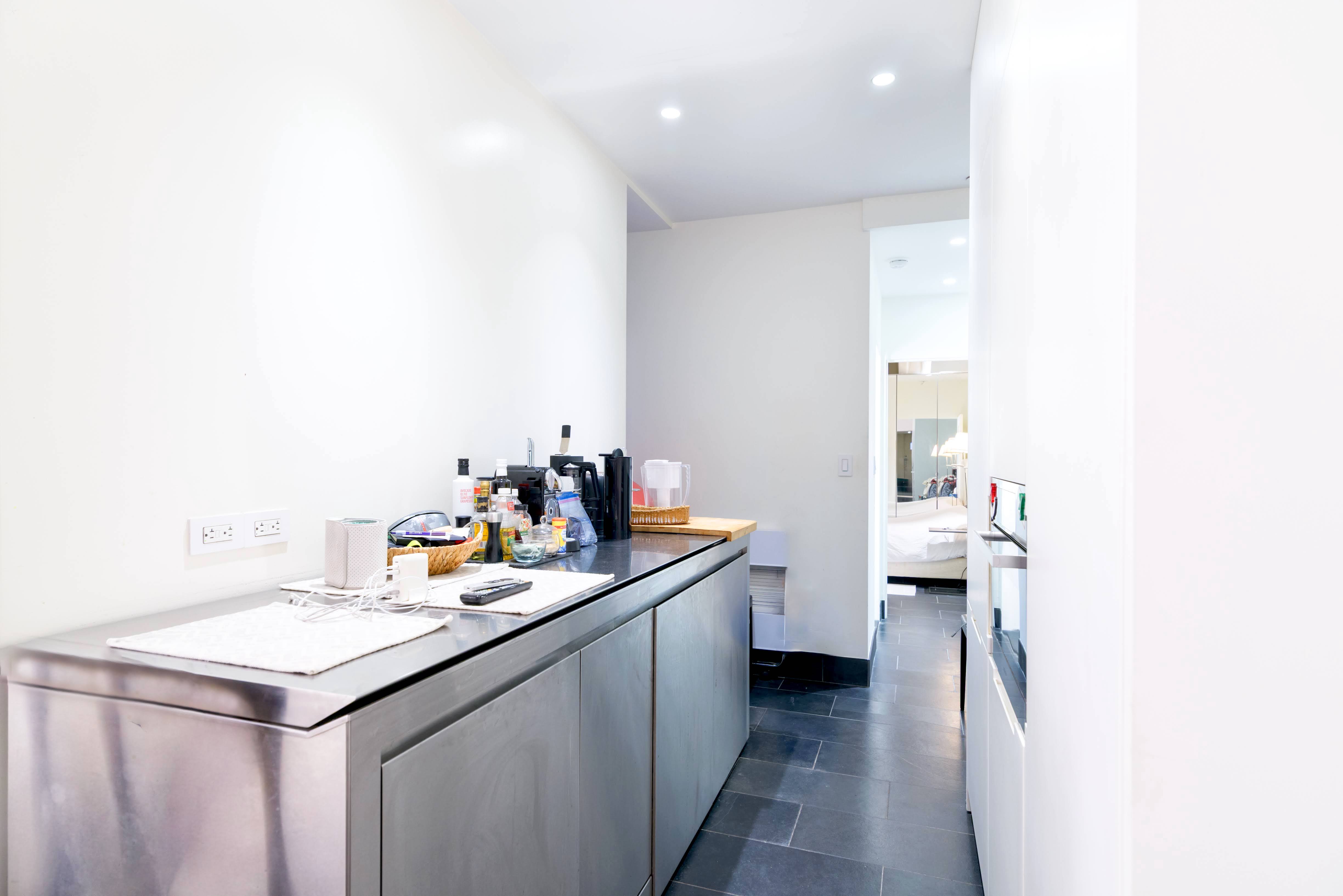 349 West 71st Street Manhattan, NY 10023 - Photo 17 of 21 a kitchen with a sink and cabinets