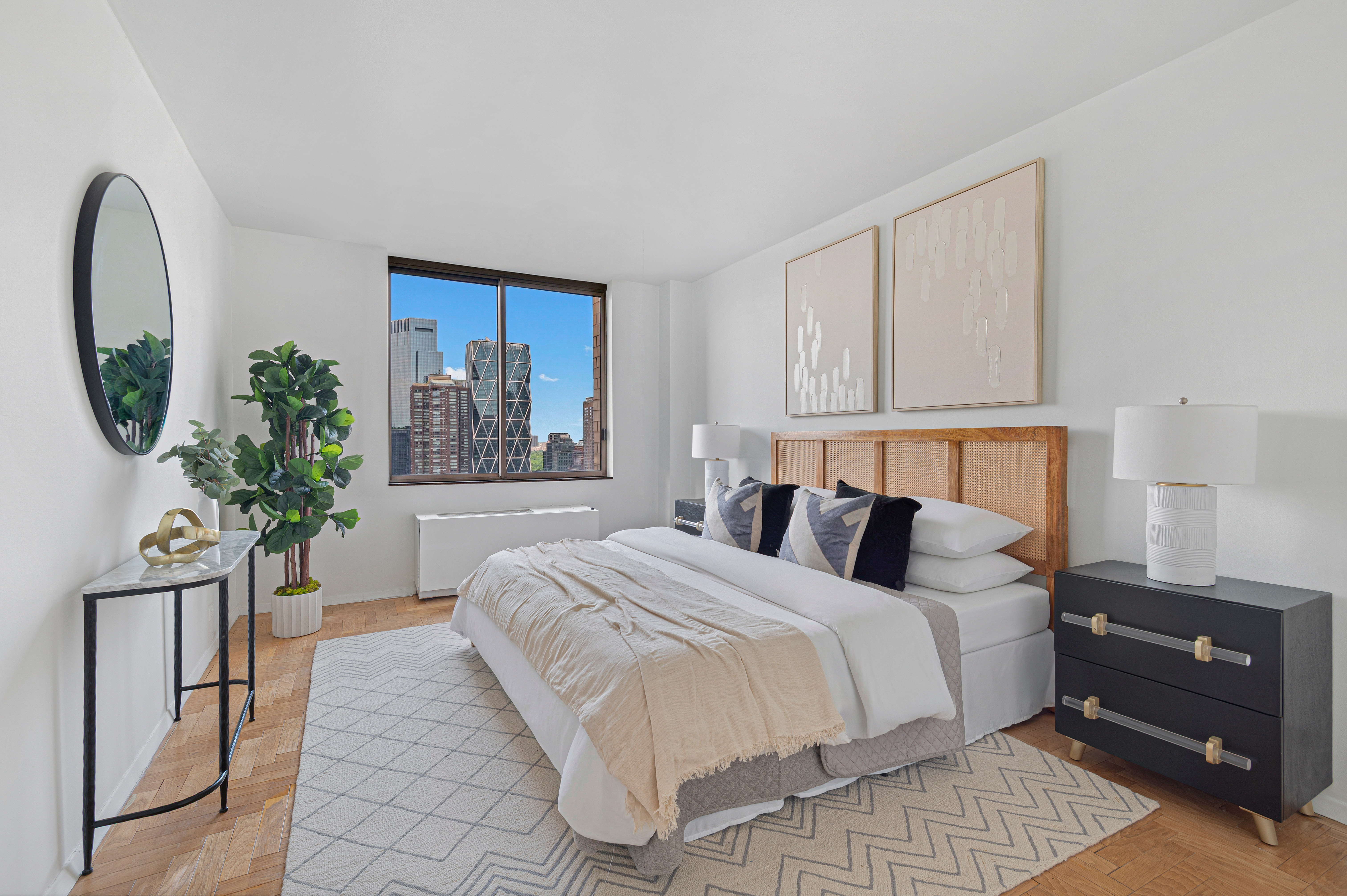 350 West 50th Street, Unit PH3C Manhattan, NY 10019 - Photo 10 of 17 a bedroom with a large bed and a potted plant