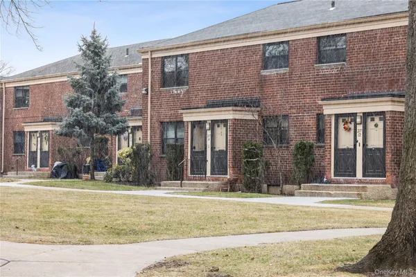 a view of a brick building next to a yard