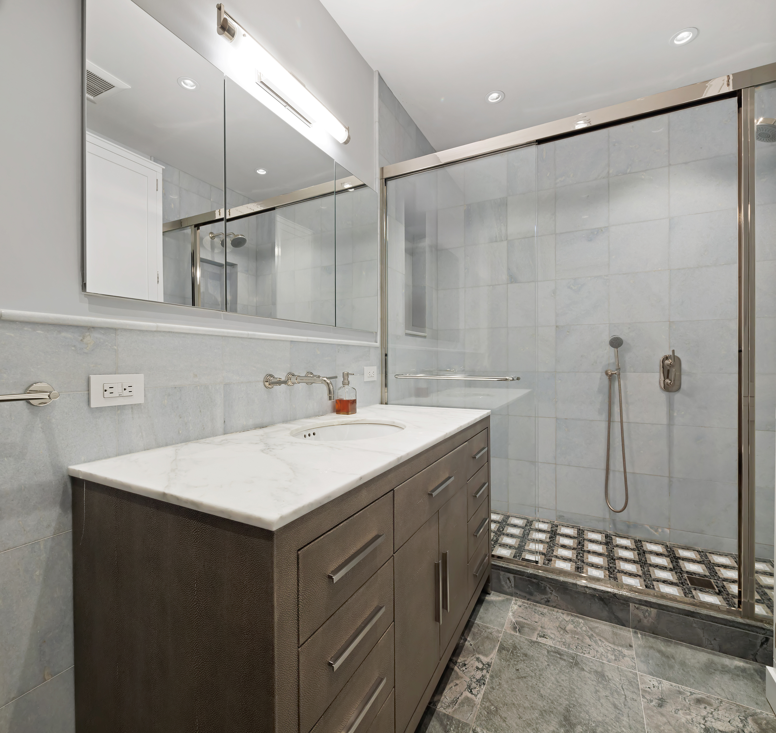 217 West 22nd Street Manhattan, NY 10011 - Photo 8 of 16 a bathroom with a sink mirror and a shower