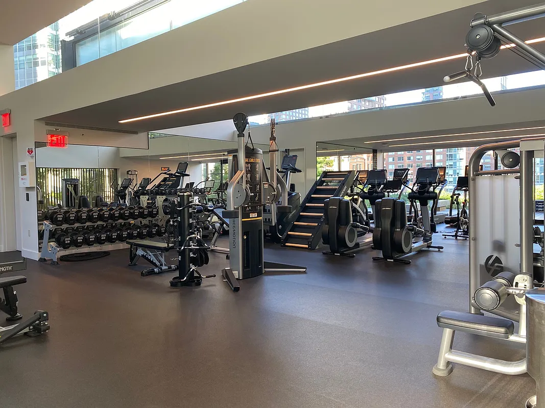 101 Warren Street, Unit 840 Manhattan, NY 10007 - Photo 7 of 16 a view of a room with gym equipment