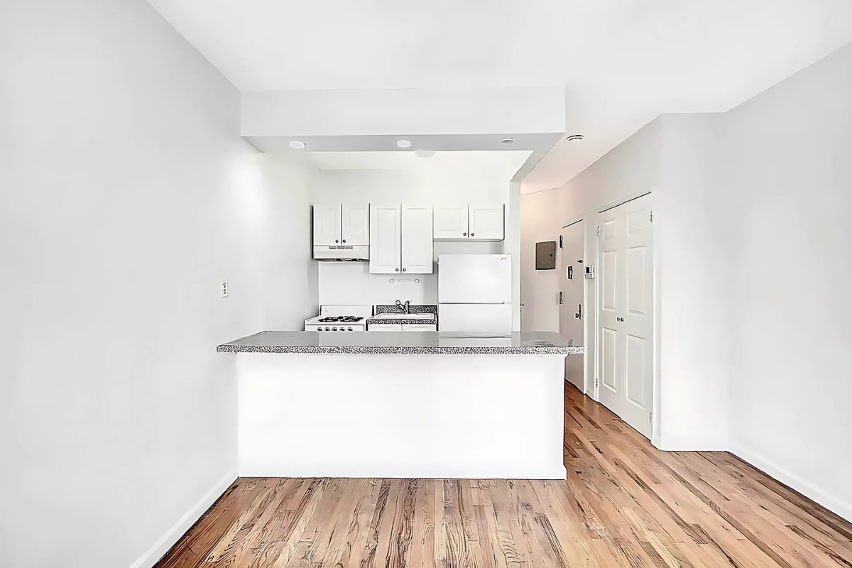 422 Amsterdam Avenue, Unit 2C Manhattan, NY 10024 - Photo 2 of 8 a kitchen with stainless steel appliances a sink and a refrigerator