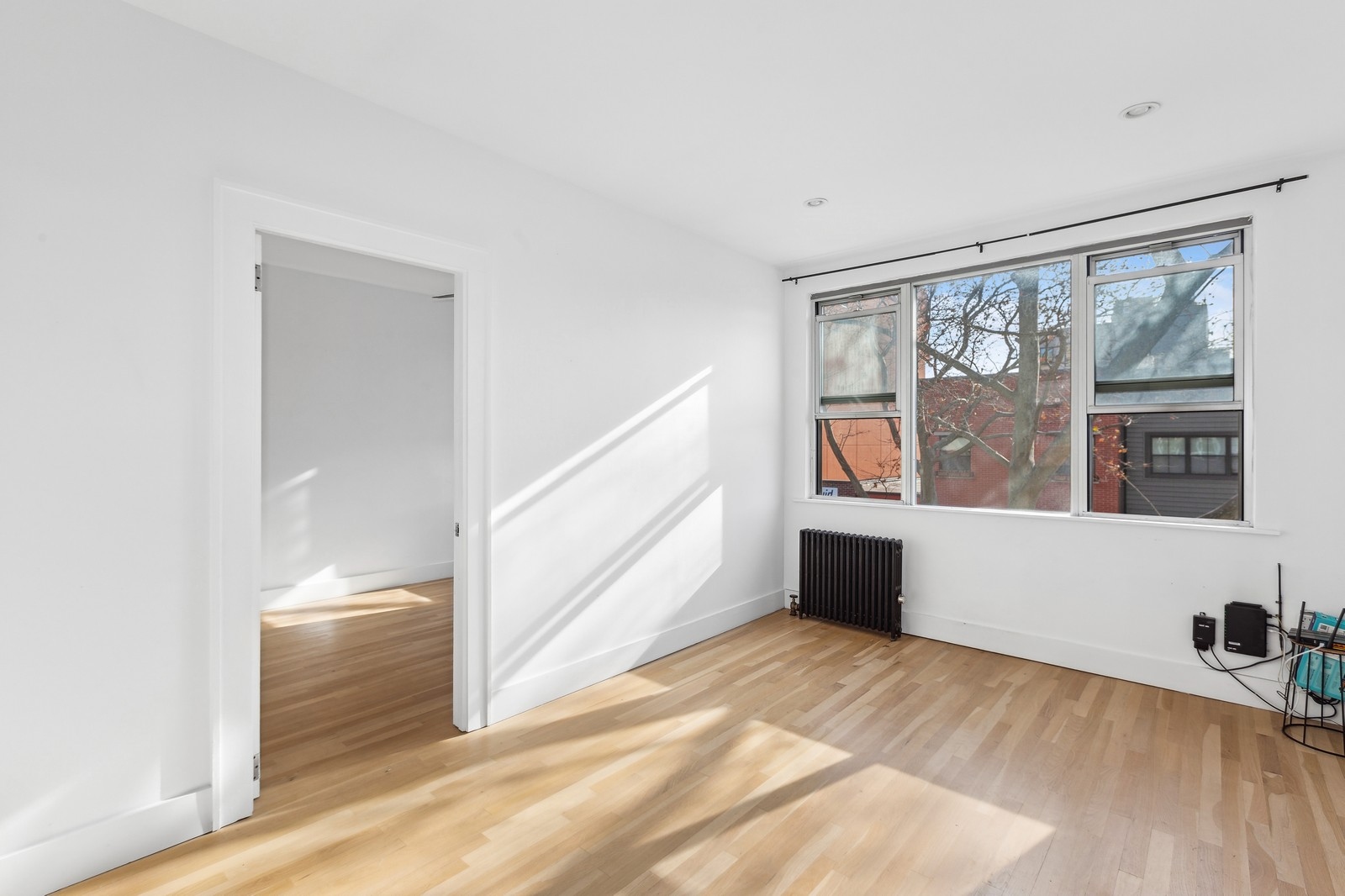 209 Frost Street, Unit 2 Brooklyn, NY 11211 - Photo 3 of 8 a view of an empty room with wooden floor and a window