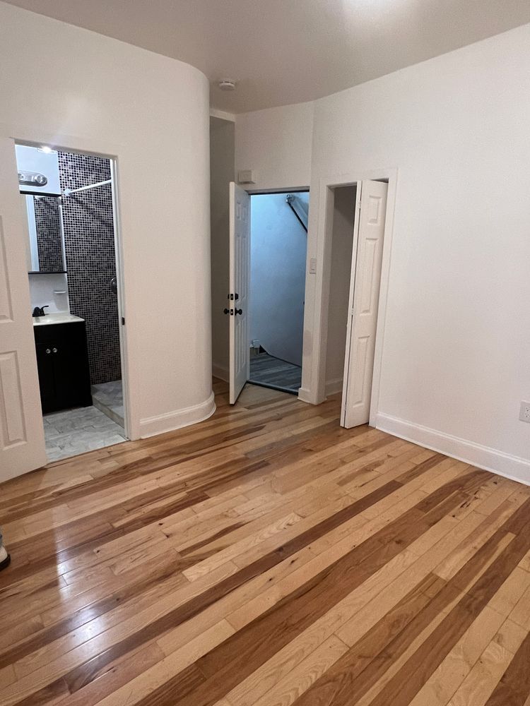 1218 Nostrand Avenue, Unit 1 Brooklyn, NY 11225 - Photo 2 of 5 a view of a livingroom with wooden floor and cabinet