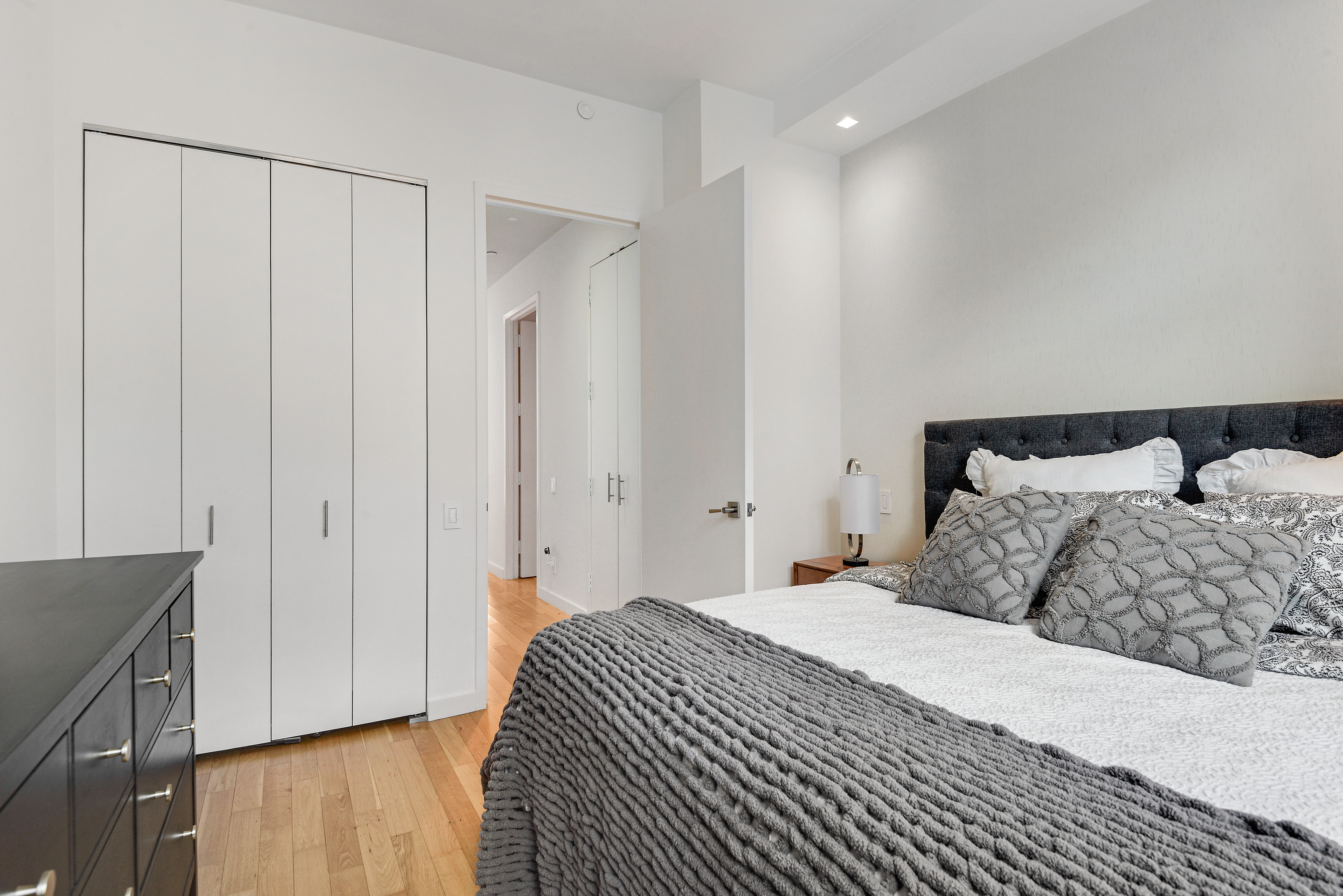 325 5th Avenue, Unit 16C Manhattan, NY 10016 - Photo 11 of 25 a bedroom with a bed and wooden floor