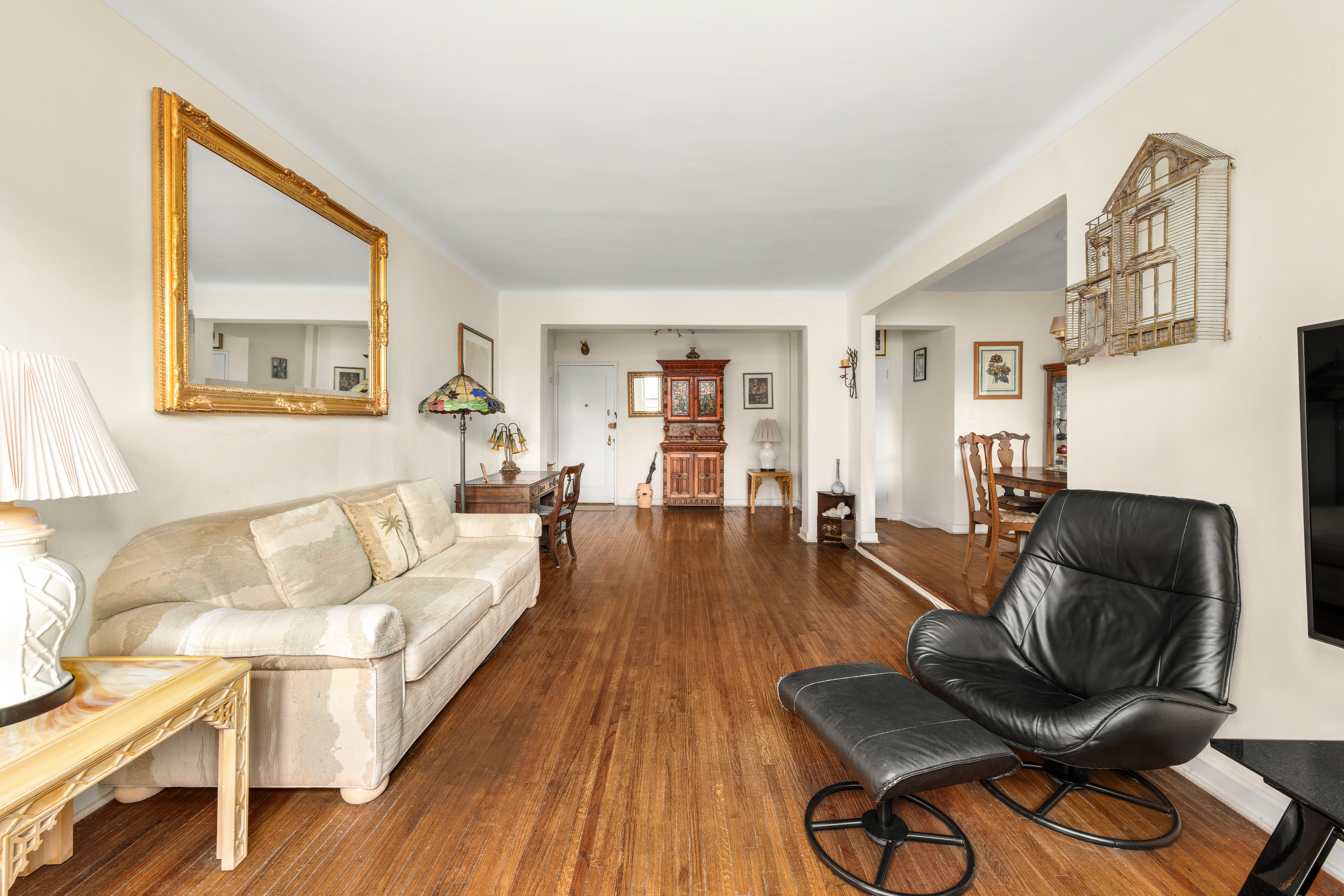 68-61 Yellowstone Boulevard, Unit 618 Queens, NY 11375 - Photo 4 of 13 a living room with furniture and a wooden floor