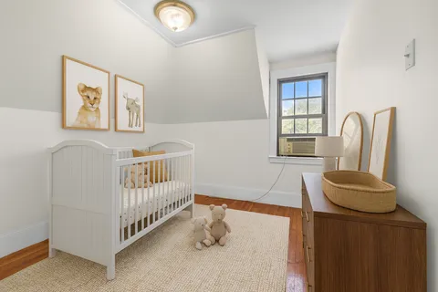 a view of a room with wooden floor and windows