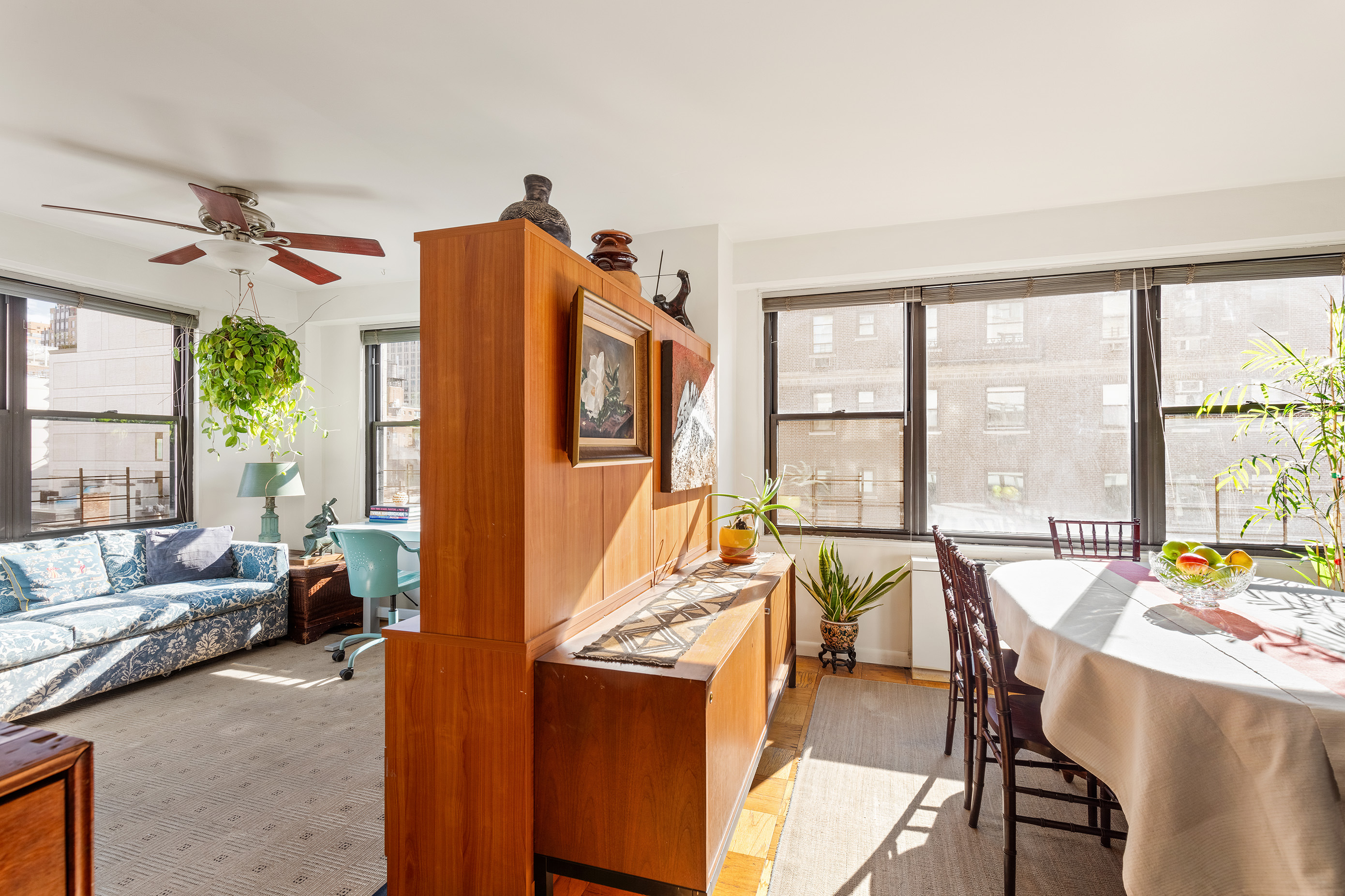 120 East 90th Street, Unit 9E Manhattan, NY 10128 - Photo 2 of 9 a dining room with furniture and a large window