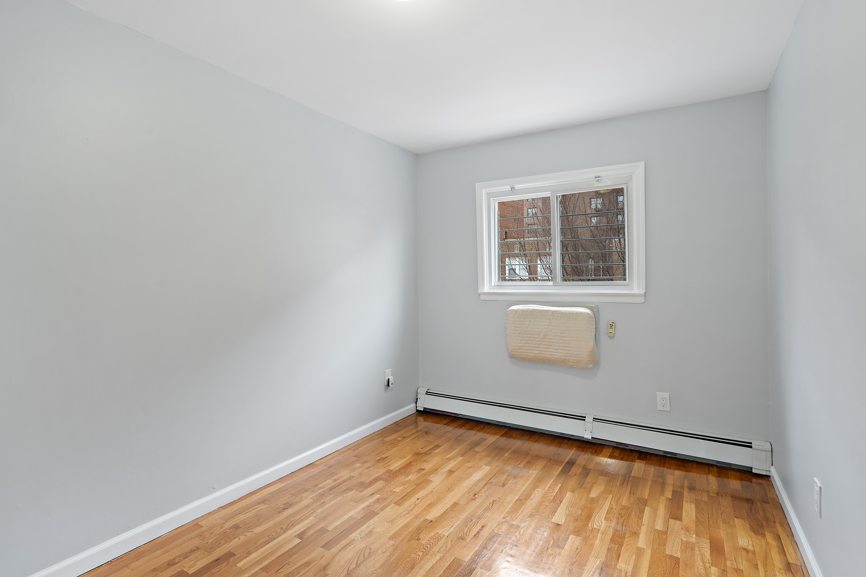 3230 Johnson Avenue, Unit 3 Bronx, NY 10463 - Photo 11 of 21 a view of empty room with wooden floor and fan