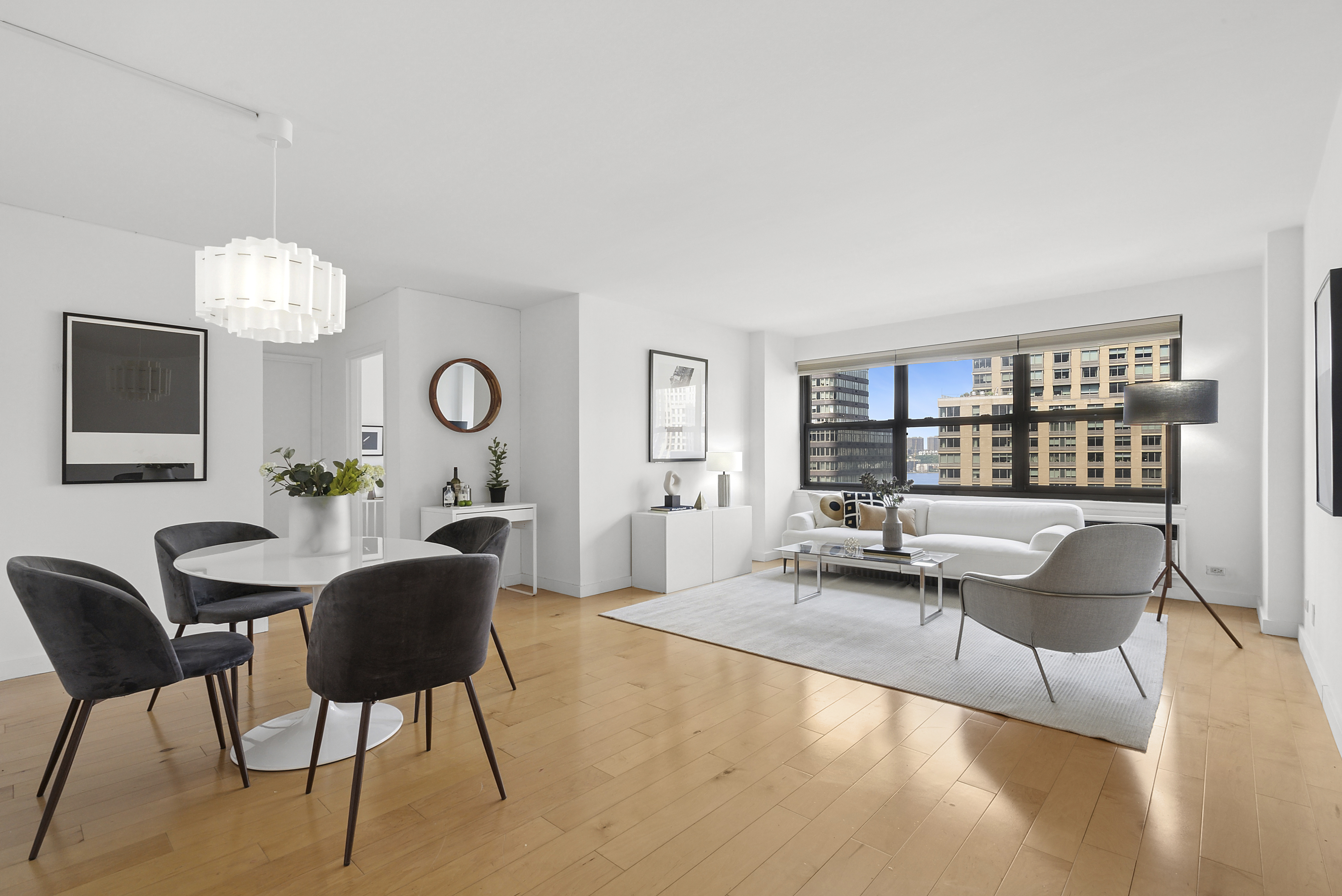 a living room with furniture a chandelier and a flat screen tv
