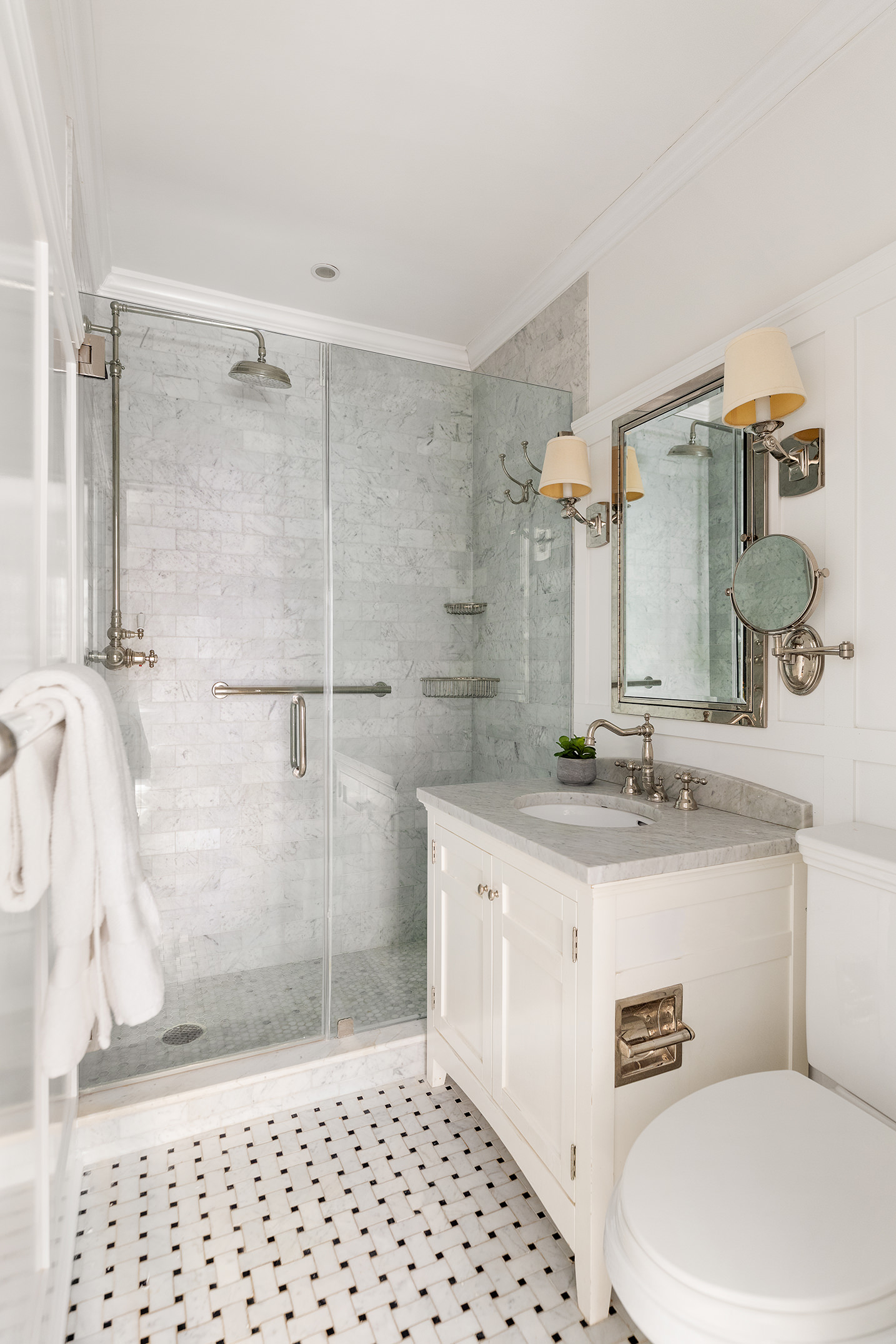 115 East 67th Street, Unit 3C Manhattan, NY 10065 - Photo 14 of 21 a bathroom with a granite countertop sink a toilet a mirror and shower